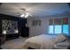 Relaxing bedroom featuring a black accent wall, neutral colors and great natural light at 4799 Winterview Ln, Douglasville, GA 30135
