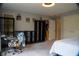 Bright bedroom featuring neutral gray walls, black shelving, and a glimpse into the kitchen at 4799 Winterview Ln, Douglasville, GA 30135
