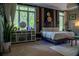 Well-lit bedroom with large windows, modern décor, and natural accents creating a relaxing and stylish space at 4799 Winterview Ln, Douglasville, GA 30135