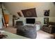 Large bedroom with recliners, carpet flooring, and access ladder at 4799 Winterview Ln, Douglasville, GA 30135