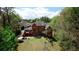 Rear exterior view of brick home with a sprawling deck and lush greenery, offering privacy and a connection with nature at 4799 Winterview Ln, Douglasville, GA 30135