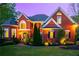 Stately brick home with meticulously landscaped front yard, including mature trees and shrubs at 4799 Winterview Ln, Douglasville, GA 30135