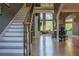 Bright foyer with hardwood floors, elegant staircase, and a view into the living area at 4799 Winterview Ln, Douglasville, GA 30135