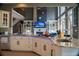 Open-concept kitchen boasts an island with granite countertop, white cabinets, stainless steel appliances, and a view to the living area at 4799 Winterview Ln, Douglasville, GA 30135