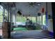 Bright sunroom featuring ample natural light, artificial grass flooring, and a unique design with views of nature at 4799 Winterview Ln, Douglasville, GA 30135