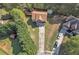 Aerial view of home with large driveway, mature trees, and a well-maintained lawn at 7228 Silverleaf Cir, Fairburn, GA 30213