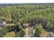 An aerial view of a home in a tranquil setting surrounded by a canopy of trees at 7228 Silverleaf Cir, Fairburn, GA 30213