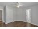 This cozy bedroom features hardwood floors, neutral paint and a ceiling fan at 7228 Silverleaf Cir, Fairburn, GA 30213