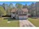 Two-story home with stone accents, attached two-car garage and well-manicured front lawn at 7228 Silverleaf Cir, Fairburn, GA 30213