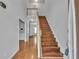 Bright foyer featuring hardwood floors, staircase to the second floor, and neutral paint at 7228 Silverleaf Cir, Fairburn, GA 30213