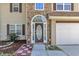 Inviting front entrance with decorative glass door, stone accents, and manicured landscaping at 7228 Silverleaf Cir, Fairburn, GA 30213