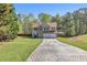 Charming home with manicured lawn, stone accents, and a spacious driveway at 7228 Silverleaf Cir, Fairburn, GA 30213