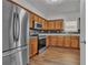 Well-equipped kitchen with stainless steel appliances, granite countertops, and wood cabinets at 7228 Silverleaf Cir, Fairburn, GA 30213