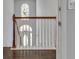 Well-lit landing with staircase leading to a bright, arched doorway, enhancing the home's charm at 7228 Silverleaf Cir, Fairburn, GA 30213
