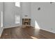 Spacious living room featuring a stone fireplace, high ceilings, and hardwood floors at 7228 Silverleaf Cir, Fairburn, GA 30213