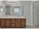 Main bathroom featuring double sink vanity with dark cabinets and a large mirror at 7228 Silverleaf Cir, Fairburn, GA 30213