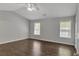 Serene main bedroom with neutral walls, hardwood floors, two windows, and ceiling fan at 7228 Silverleaf Cir, Fairburn, GA 30213
