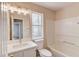 Bathroom featuring white vanity, bath, and shower with a window letting in natural light at 11205 Abbotts Station Dr, Duluth, GA 30097