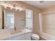 Bright bathroom featuring modern vanity, a shower-tub combo, and a large mirror at 11205 Abbotts Station Dr, Duluth, GA 30097