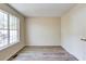 Bedroom featuring wood-look flooring, white door, and a large window that provides natural light at 11205 Abbotts Station Dr, Duluth, GA 30097