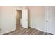 Bedroom showcasing wood-look floors, a door opening to a staircase, and another to a closet at 11205 Abbotts Station Dr, Duluth, GA 30097