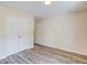 Bedroom showcasing wood-look flooring and closet with white, double doors at 11205 Abbotts Station Dr, Duluth, GA 30097
