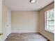 Bright bedroom featuring wood-look flooring and a window providing natural light at 11205 Abbotts Station Dr, Duluth, GA 30097