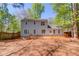 View of the home's exterior, showcasing the deck and backyard surrounded by trees at 11205 Abbotts Station Dr, Duluth, GA 30097