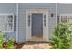 Close-up of the home's front door with sidelights, fresh paint, and tidy landscaping at 11205 Abbotts Station Dr, Duluth, GA 30097