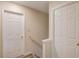 Hallway featuring neutral walls, wood-look floors, and two doors for bedroom or closet access at 11205 Abbotts Station Dr, Duluth, GA 30097