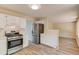 Modern kitchen featuring stainless steel appliances, white cabinetry, and new flooring at 11205 Abbotts Station Dr, Duluth, GA 30097