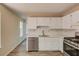 Modern kitchen showcasing stainless steel appliances, white cabinets, and stylish countertops and flooring at 11205 Abbotts Station Dr, Duluth, GA 30097