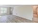 Open-concept living room with new flooring and abundant natural light at 11205 Abbotts Station Dr, Duluth, GA 30097