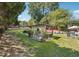 Expansive backyard featuring an outdoor dining area and mature landscaping at 1490 Rivershyre Pkwy, Lawrenceville, GA 30043
