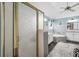 Bright bathroom featuring shower, tub, and double sink with decorative rug at 1490 Rivershyre Pkwy, Lawrenceville, GA 30043