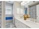 Bathroom with double sink vanity, white cabinets, and decorative shower curtain at 1490 Rivershyre Pkwy, Lawrenceville, GA 30043