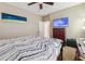 Bedroom with neutral walls and modern decor, featuring a chest of drawers, carpet, and a mounted TV at 1490 Rivershyre Pkwy, Lawrenceville, GA 30043