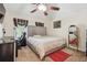 Bedroom with a plush gray headboard, a TV, desk, ceiling fan, and a mirror at 1490 Rivershyre Pkwy, Lawrenceville, GA 30043