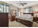 Bedroom with dark wooden furniture, including a dresser and nightstands, along with carpet floors and natural lighting at 1490 Rivershyre Pkwy, Lawrenceville, GA 30043