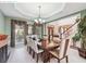 Charming dining room with a large window, elegant lighting, and comfortable seating for eight at 1490 Rivershyre Pkwy, Lawrenceville, GA 30043
