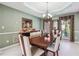 Bright dining area with ample seating, elegant lighting and a large window for natural light at 1490 Rivershyre Pkwy, Lawrenceville, GA 30043