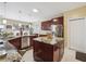 Well-lit kitchen with an island, stainless appliances, ample counter space, and modern finishes at 1490 Rivershyre Pkwy, Lawrenceville, GA 30043