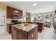 Modern kitchen with granite counters, island seating, stainless steel appliances, and a view of the dining area at 1490 Rivershyre Pkwy, Lawrenceville, GA 30043
