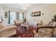 Elegant living room with classic furnishings, a chandelier, and natural light from the window at 1490 Rivershyre Pkwy, Lawrenceville, GA 30043