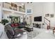Bright living room with a stone fireplace, an open floor plan and access to the second floor at 1490 Rivershyre Pkwy, Lawrenceville, GA 30043