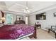Spacious bedroom with ensuite bathroom, television, dark furniture, and plush carpet at 1490 Rivershyre Pkwy, Lawrenceville, GA 30043