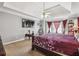 Large bedroom with tray ceiling, mounted TVs, and a seating area at 1490 Rivershyre Pkwy, Lawrenceville, GA 30043