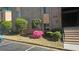Condominium building featuring well-maintained landscaping with manicured shrubs and stairs to the entrance at 2388 Lawrenceville Hwy # D, Decatur, GA 30033