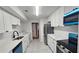 Modern kitchen featuring white cabinets, stainless steel appliances, and a sleek countertop at 2388 Lawrenceville Hwy # D, Decatur, GA 30033