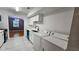 Kitchen featuring washer/dryer connections, white cabinets and white countertops at 2388 Lawrenceville Hwy # D, Decatur, GA 30033